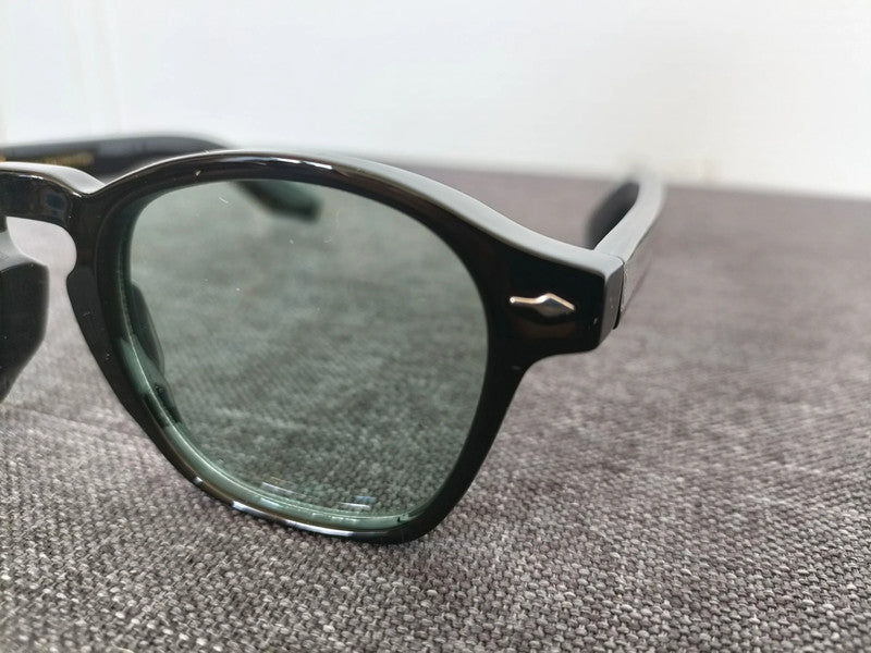 Black pantos glasses with green lenses